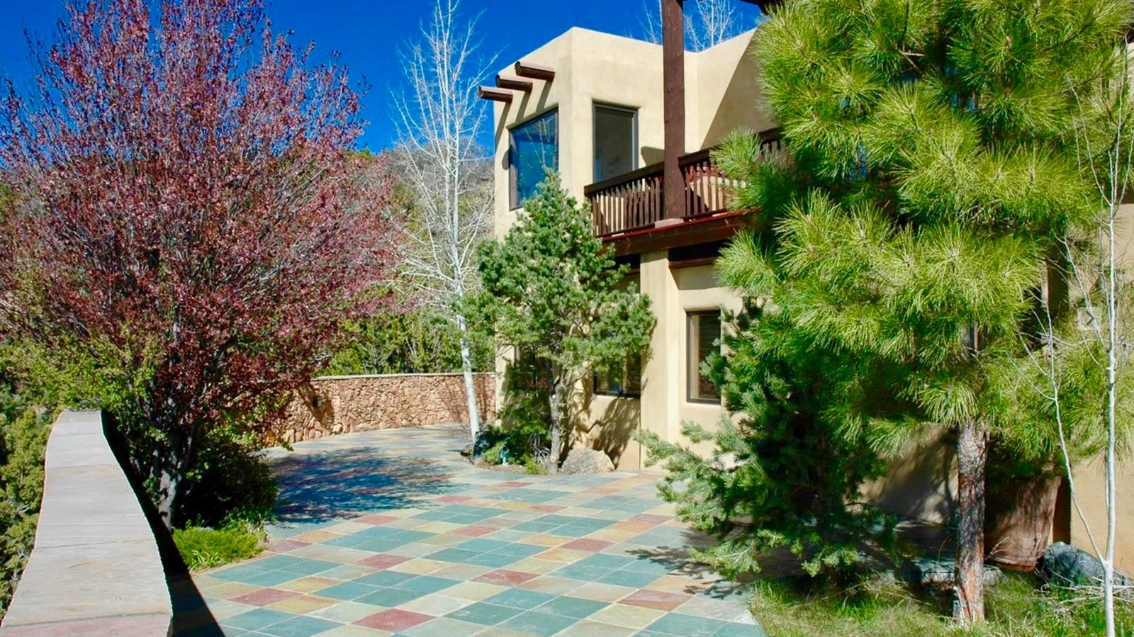 Santa Fe residence exterior terrace with trees and mountain light
